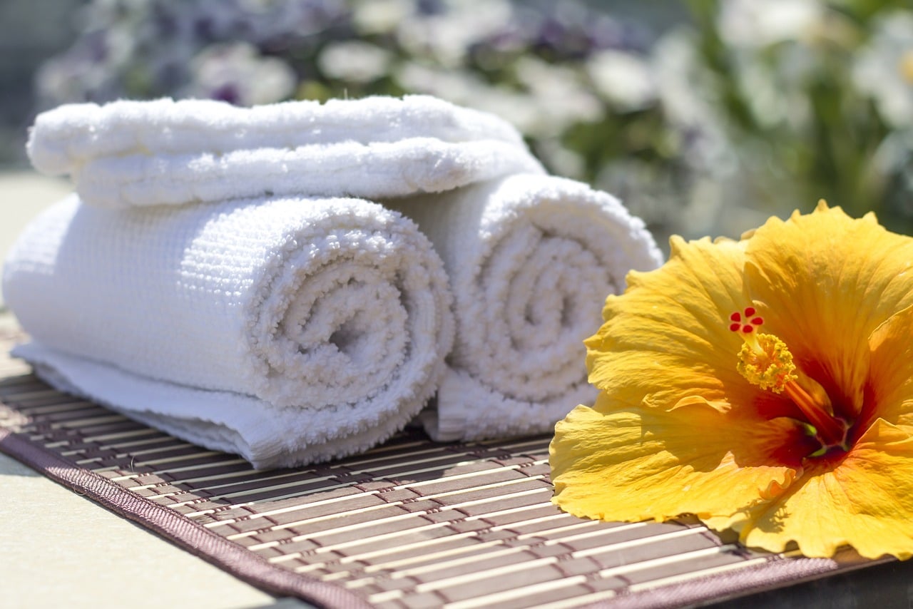 Bamboo towels next to hibiscus flower